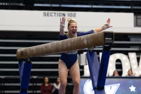 Simone Banen celebrates her beam routine.