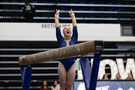 Simone Banen celebrates beam routine