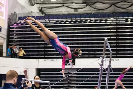 Deja Chambliss competes on bars.