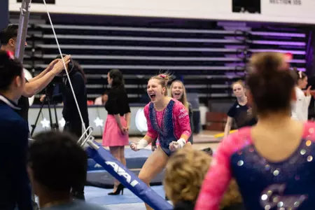 Simone Banen celebrates her bar routine.