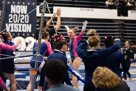 Simone Banen celebrates her bar routine.
