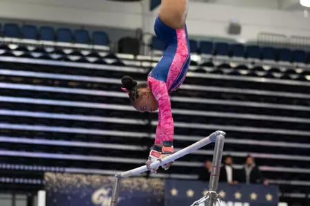 Deja Chambliss competes on bars.