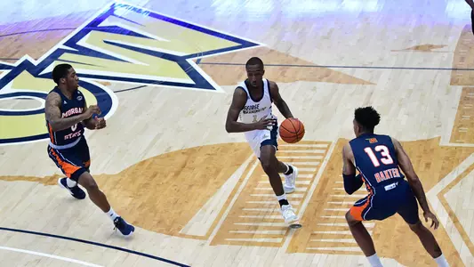 Shawn Walker Jr. dribbles through two defenders vs. Morgan State