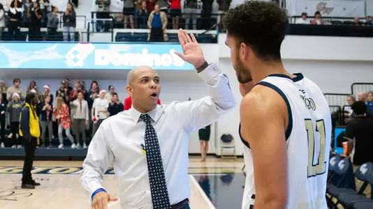 Head Coach Jamion Christian High Fives Arnaldo Toro