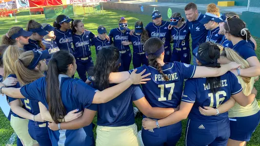GW softball hudles around head coach Shane Winkler