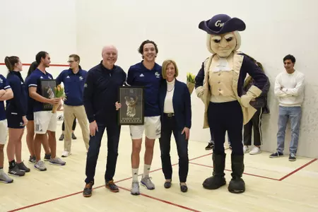 Geordie Laird and family posing with George at senior game.