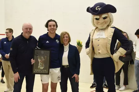 Geordie Laird and family posing with George at senior game.