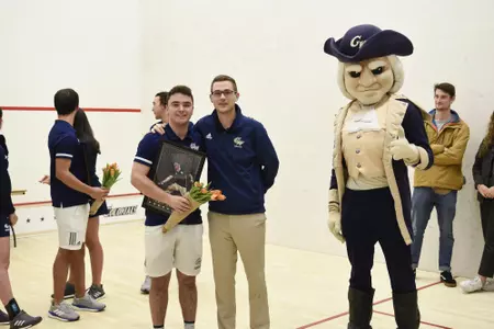 Jamie Oakley and Head Coach Anderson Good posing with George.