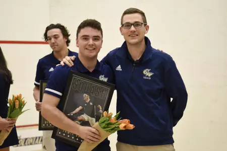 Jamie Oakley and Head Coach Anderson Good posing during senior game celebration.