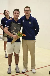 Jamie Oakley and Head Coach Anderson Good posing during senior game celebration.