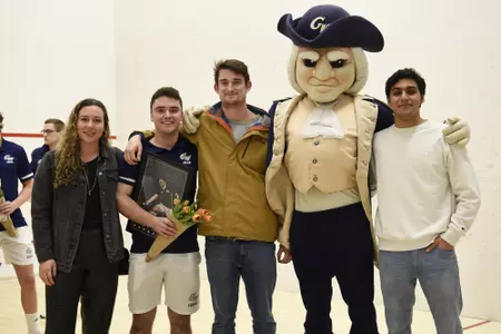 Jamie Oakley and family posing with George during senior game celebration.