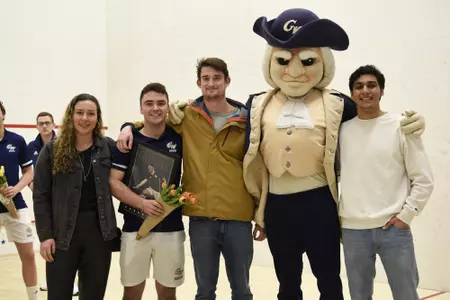Jamie Oakley and family posing with George during senior game celebration.