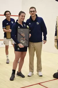 Emma Tyron and Head Coach Anderson Good during senior game celebration.