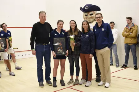 Emma Tyron and family posing with Head Coach Anderson Good and George.