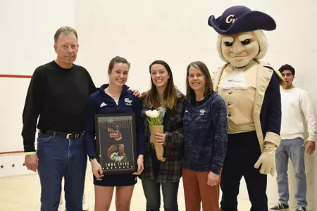 Emma Tyron and family posing with George during senior game celebration.