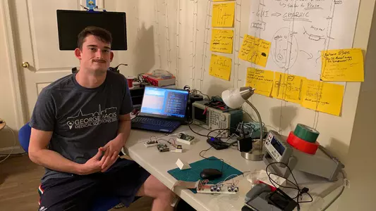 Matt Taylor poses at his work space in his apartment