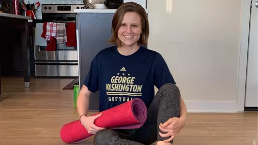 Sandi Gohn poses at home with her yoga mat.