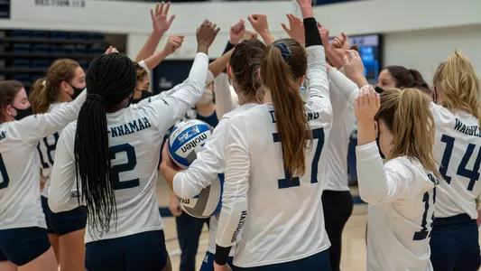 The volleyball team huddles