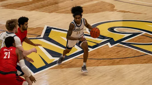 James Bishop dribbles down court vs. Duquesne