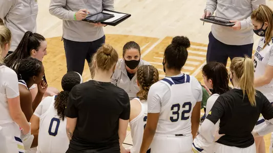 Women's basketball coach Jen Rizzotti speaks to the team during a timeout.