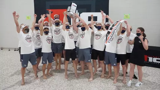 GW Men's Swimming & Diving celebrates its 2021 A-10 title.