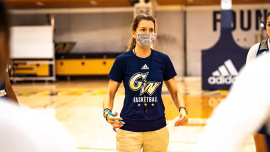 Caroline McCombs leads GW women's basketball at a preseason practice.