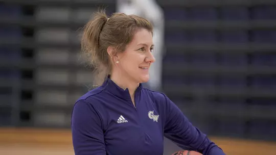 Caroline McCombs leads GW women's basketball at a preseason practice.