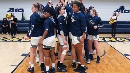 Women's Basketball huddles up during game against VT