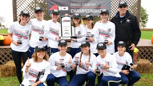 GW women's cross country celebrates its 2021 A-10 title.