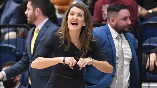 GW Women's Basketball Head Coach Caroline McCombs on the sidelines against American in her coaching debut