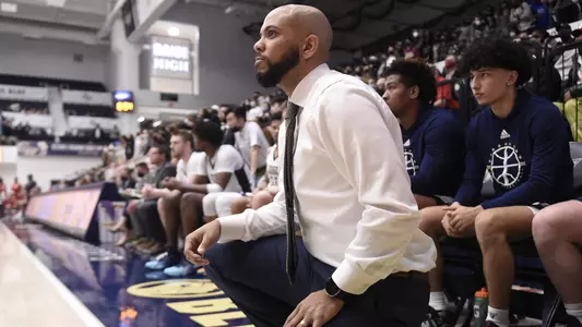 Jamion Christian kneels in front of his bench