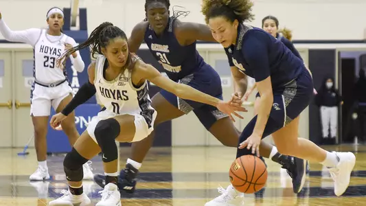 Sheslanie Laureano and Mayowa Taiwo go after a loose ball against Georgetown