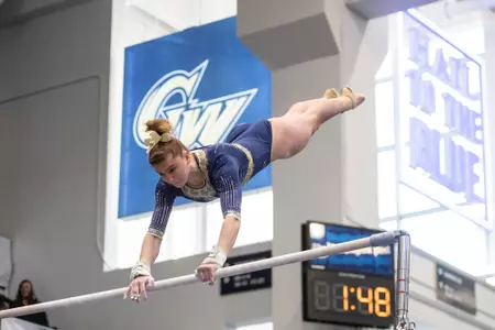 Olivia Raymond competes on bars at a meet