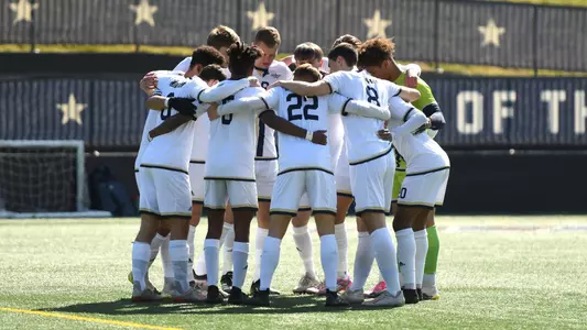 GW Men's Soccer huddles before kickoff.
