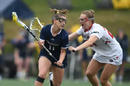 Bailey Aaron cradles by a Davidson defender