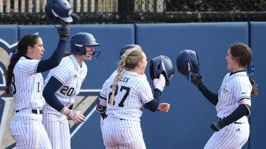 GW softball celebrates a home run vs. Mount St. Mary's.
