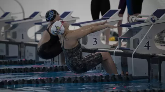 Andrea Ho starts a backstroke race.