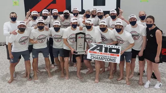 GW Men's Swimming & Diving celebrates its 2021 A-10 title.