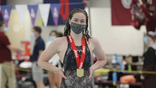 Erin McCarthy poses with her gold medal after the 1,650 free.