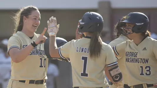 Jenna Cone is greeted by Jessica Linquist and Sierra Lange in the A-10 Championship win over Saint Joseph's.