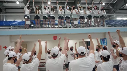 GW swimming and diving celebrates after the 2021 A-10 Championships.