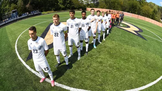 GW men's soccer lines up for the national anthem.