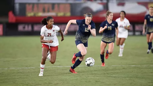 Maggie Mockenhaupt dribbles downfield vs Maryland