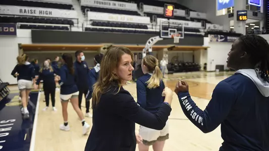 Coach McCombs and the team enter against URI