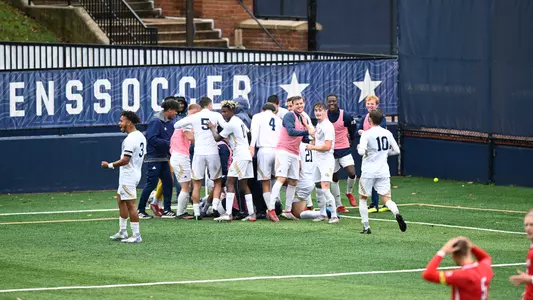Men's Soccer celebrates on the sideline