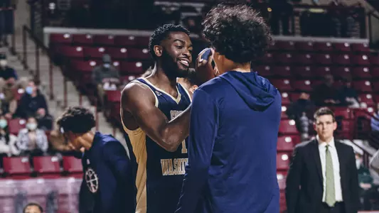 Joe Bamisile shakes hands during starting lineup