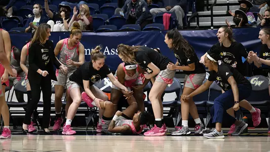 GW women's basketball celebrates Kyara Frames' four point play against George Mason