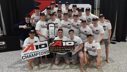 GW men's swimming & diving celebrates its 2022 A-10 title.