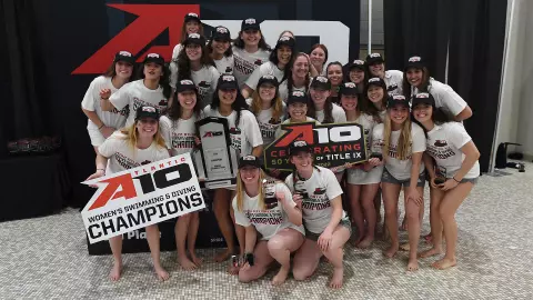 GW women's swimming & diving celebrates its 2022 A-10 title.