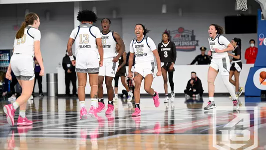 Women's Basketball celebrates a Kyara Frames three in the first round of the A-10 Tournament